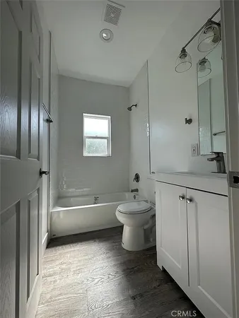 a bathroom with a sink a toilet and a bathtub