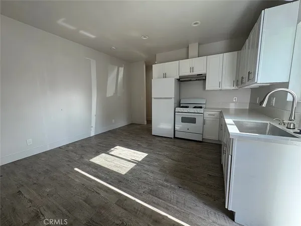 a kitchen with a sink stainless steel appliances and cabinets
