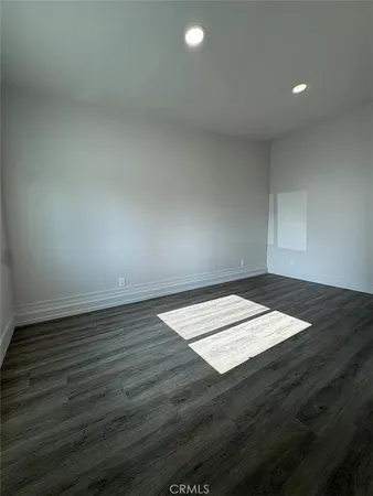 an empty room with wooden floor