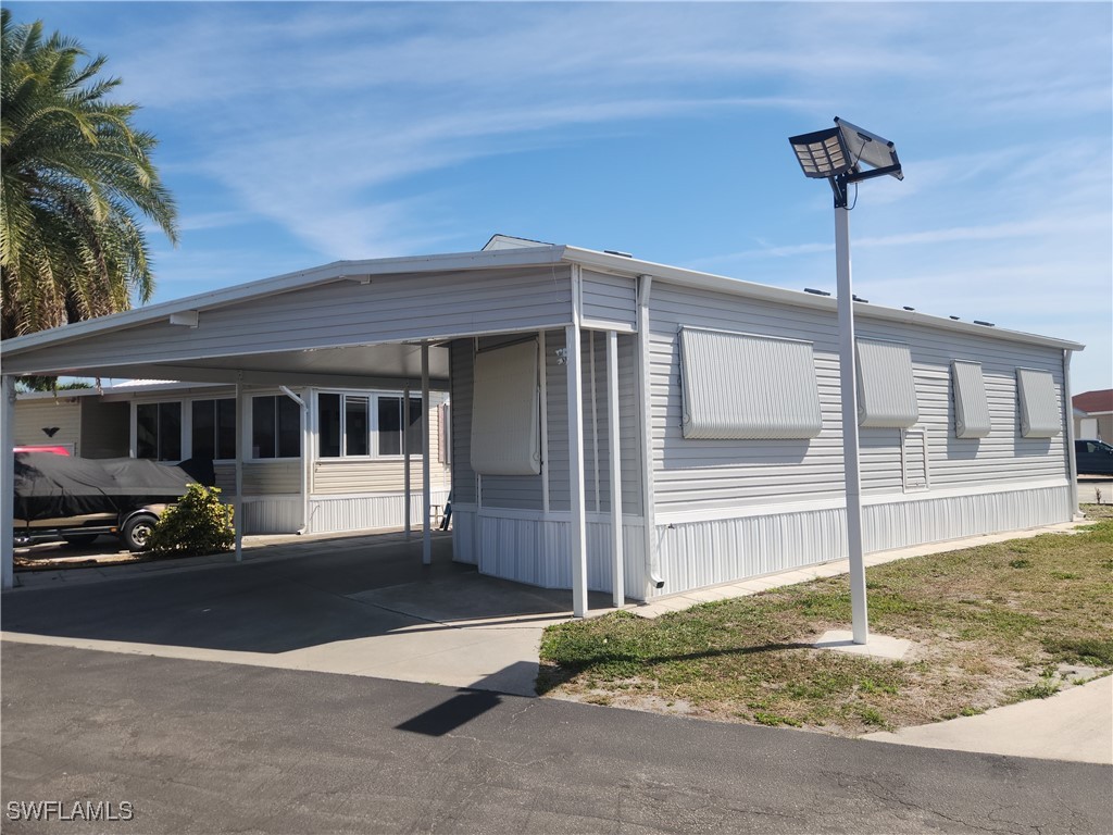 1159 Daniels Road, Unit 74 Moore Haven, FL 33471 - Photo 1 of 37 a front view of a house with a garden