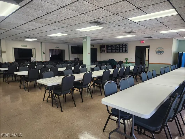 a room with pool table windows and furniture
