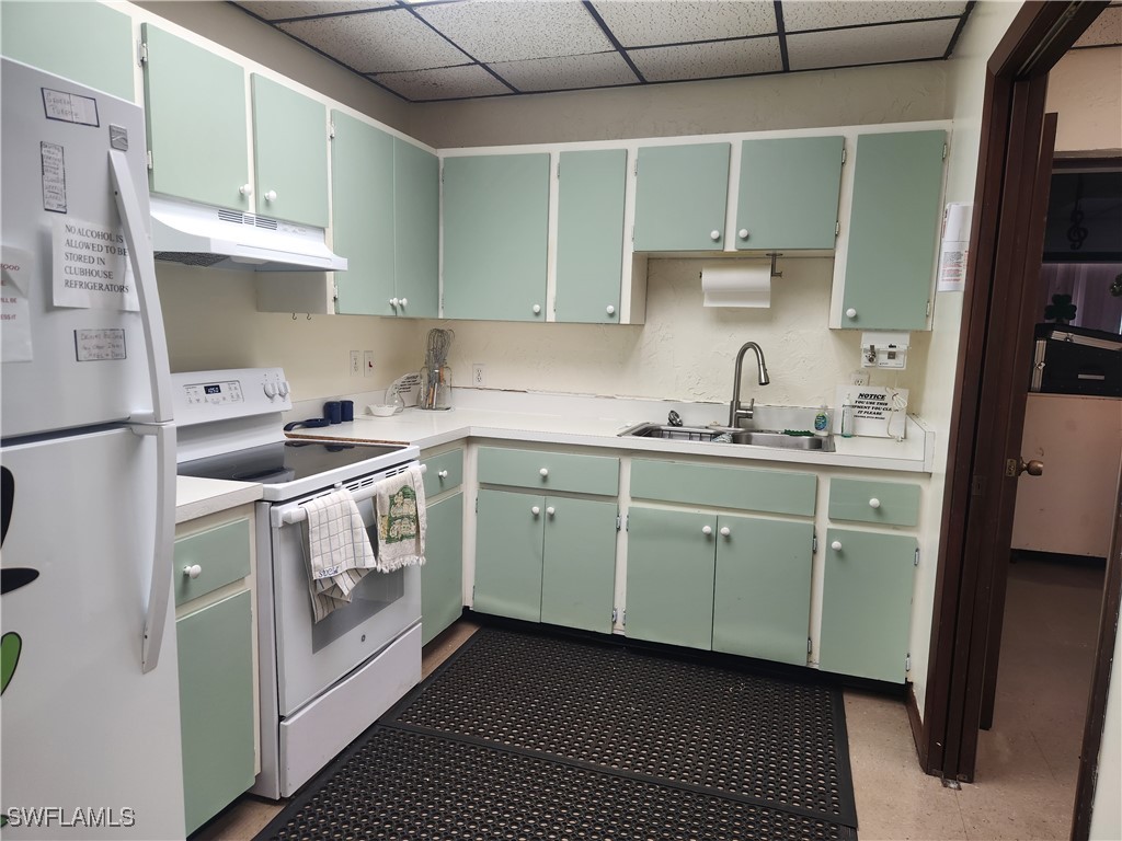 1159 Daniels Road, Unit 74 Moore Haven, FL 33471 - Photo 23 of 37 a kitchen with cabinets stainless steel appliances and a sink