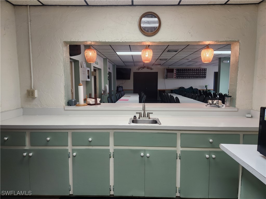 1159 Daniels Road, Unit 74 Moore Haven, FL 33471 - Photo 24 of 37 a bathroom with a sink and a large mirror