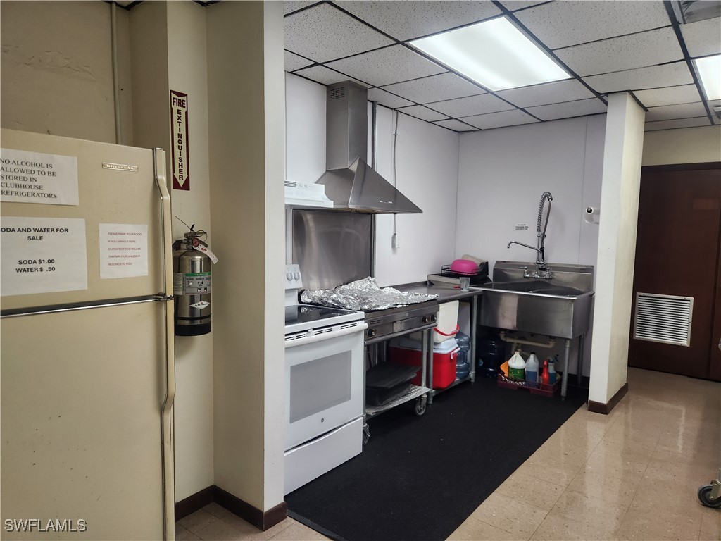 1159 Daniels Road, Unit 74 Moore Haven, FL 33471 - Photo 25 of 37 a kitchen with stainless steel appliances granite countertop a refrigerator and a stove