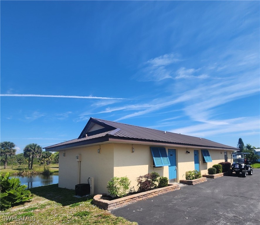 1159 Daniels Road, Unit 74 Moore Haven, FL 33471 - Photo 28 of 37 a view of a house with a patio