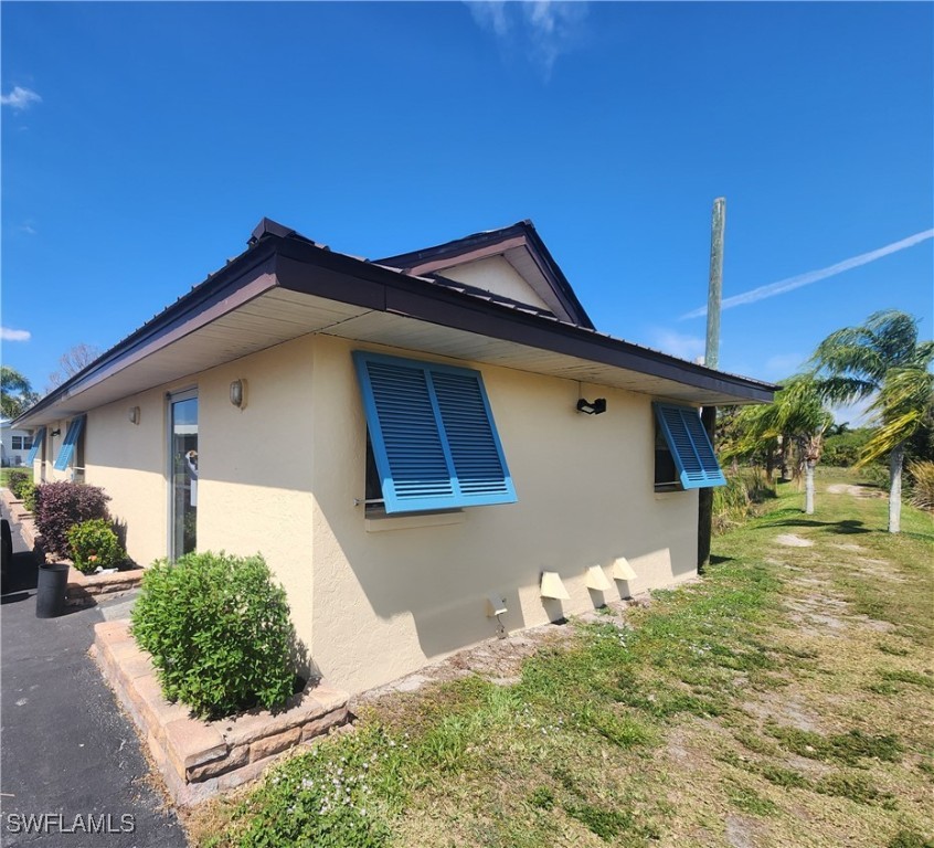 1159 Daniels Road, Unit 74 Moore Haven, FL 33471 - Photo 29 of 37 a front view of a house with garden