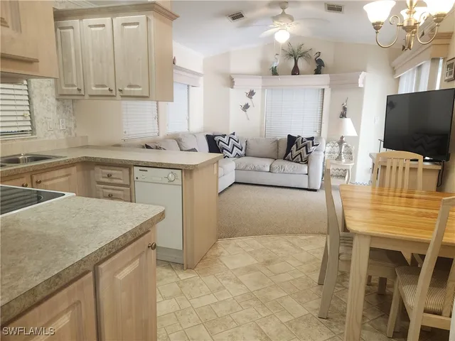 a kitchen with a stove a sink and a refrigerator