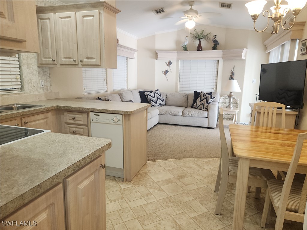 1159 Daniels Road, Unit 74 Moore Haven, FL 33471 - Photo 3 of 37 a kitchen with a stove a sink and a refrigerator
