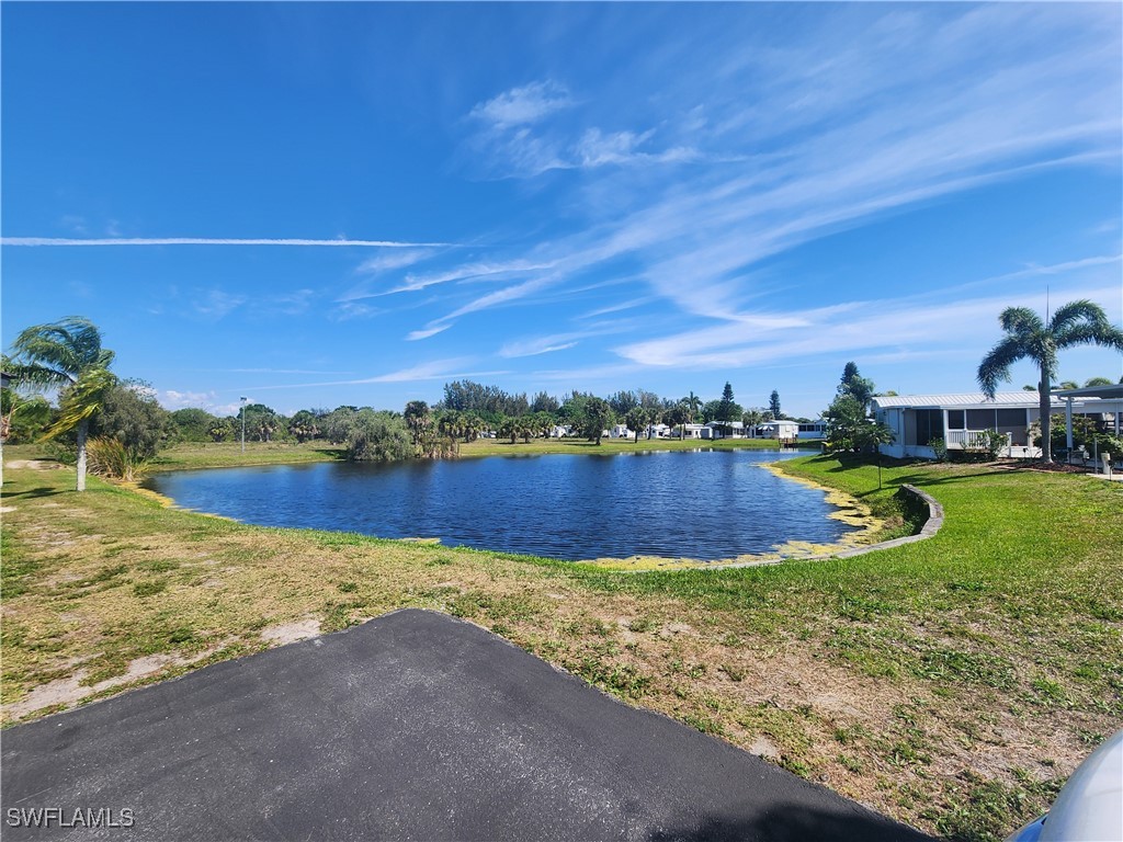 1159 Daniels Road, Unit 74 Moore Haven, FL 33471 - Photo 32 of 37 a view of a lake in front of house