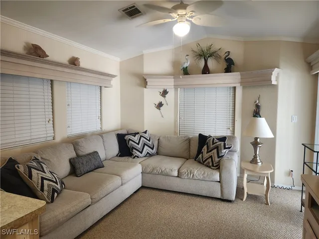 a living room with furniture and a lamp