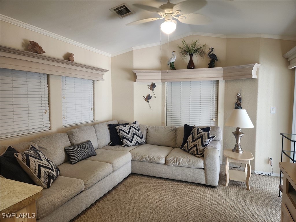 1159 Daniels Road, Unit 74 Moore Haven, FL 33471 - Photo 5 of 37 a living room with furniture and a lamp