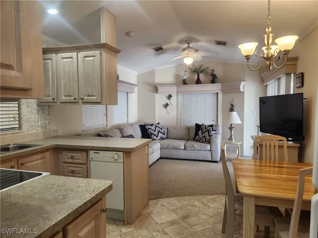 a living room with kitchen island furniture and a flat screen tv