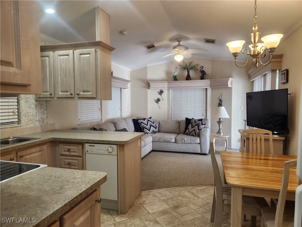 1159 Daniels Road, Unit 74 Moore Haven, FL 33471 - Photo 6 of 37 a living room with kitchen island furniture and a flat screen tv
