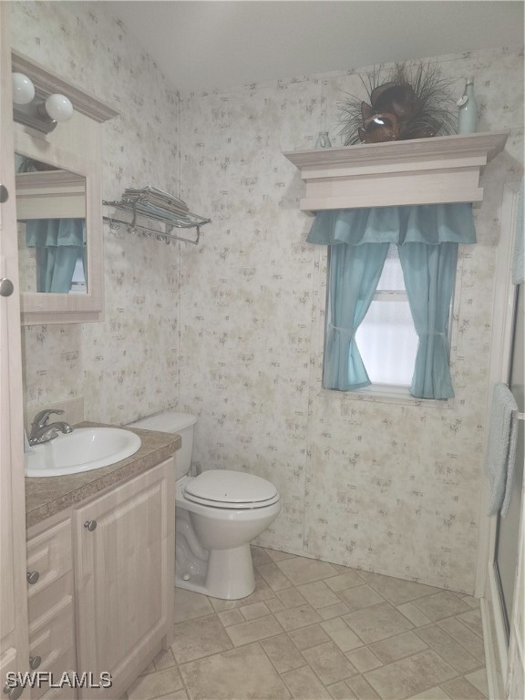 1159 Daniels Road, Unit 74 Moore Haven, FL 33471 - Photo 10 of 37 a bathroom with a toilet sink and mirror