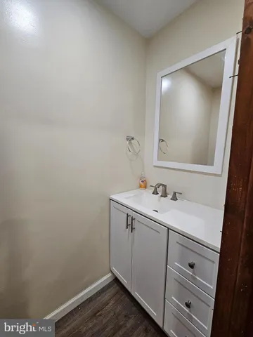 a view of bathroom with a sink and mirror