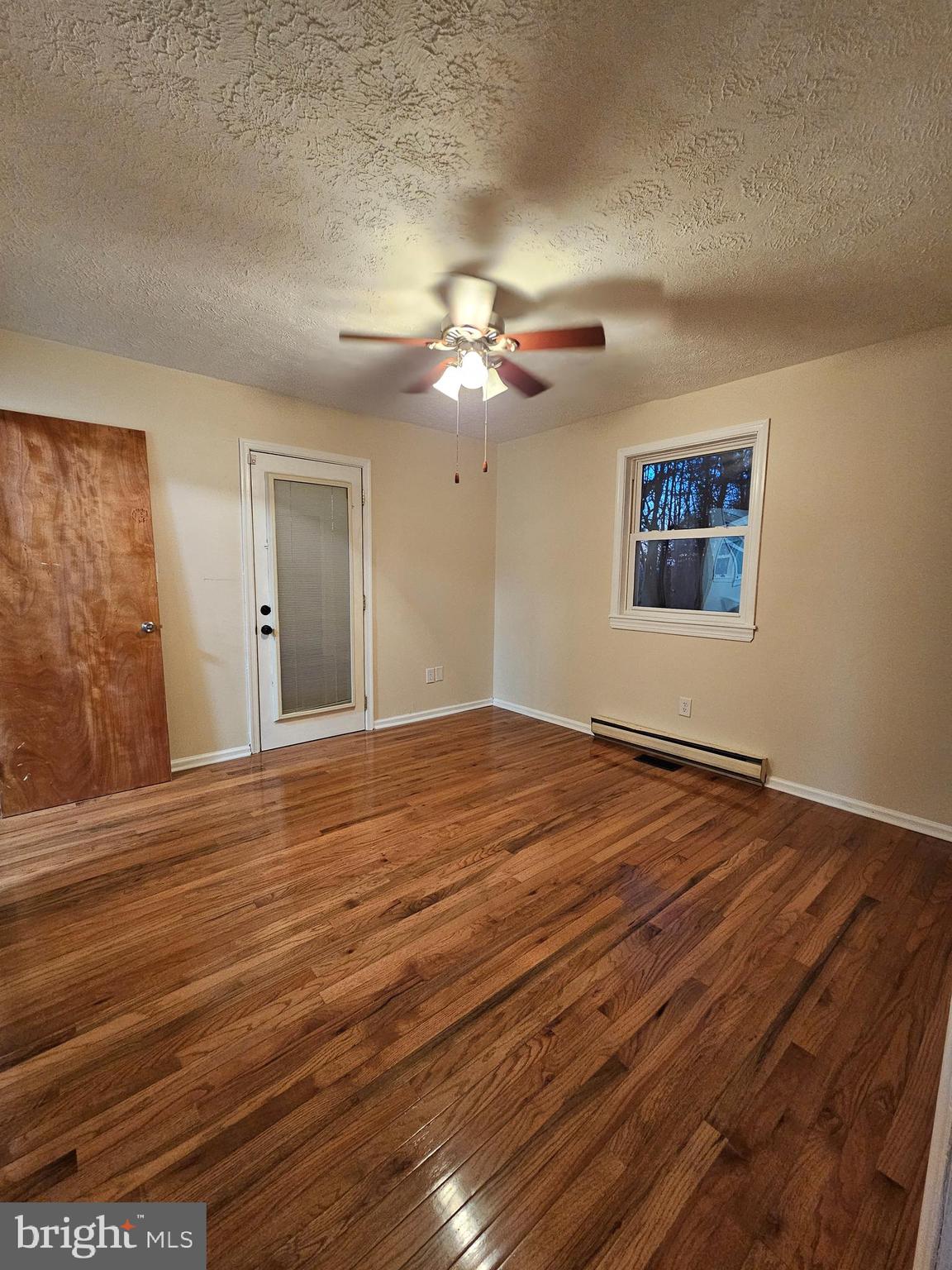 310 Blue Mountain Road Front Royal, VA 22630 - Photo 21 of 24 a view of a room with wooden floor and a ceiling fan