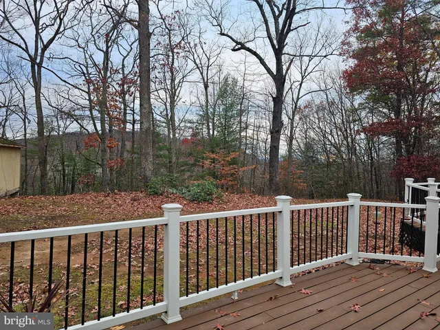 a balcony with wooden floor and fence