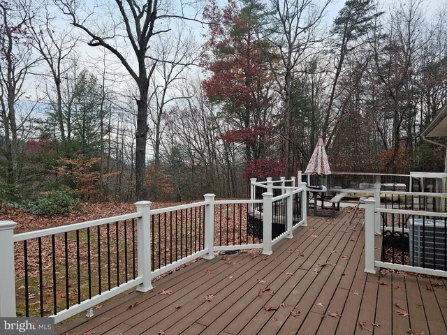 a view of a wooden deck and a yard