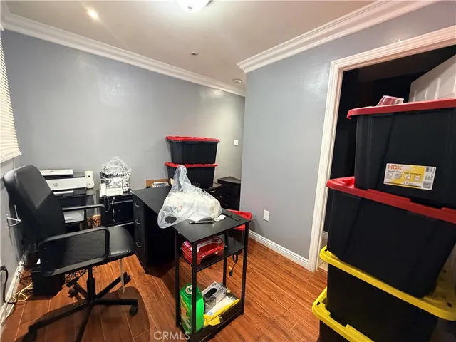 a view of a workspace with furniture and wooden floor
