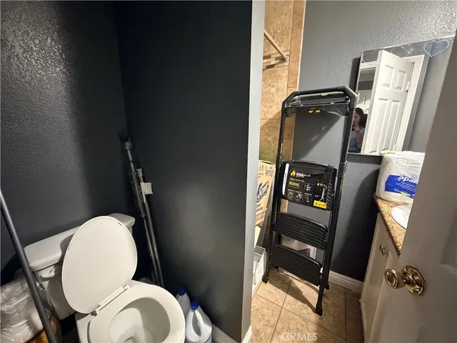 a bathroom with a toilet mirror and a sink