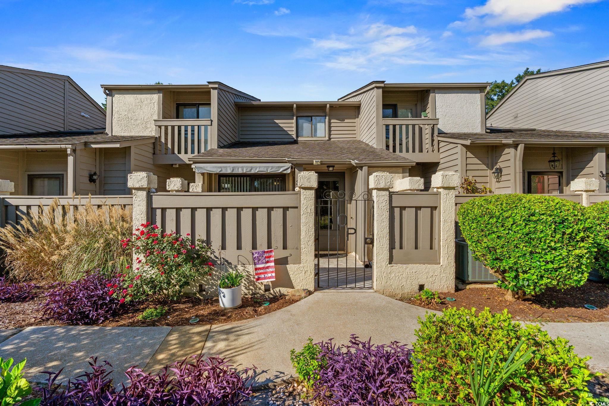 View of front of home featuring a gate and a fenced front yard