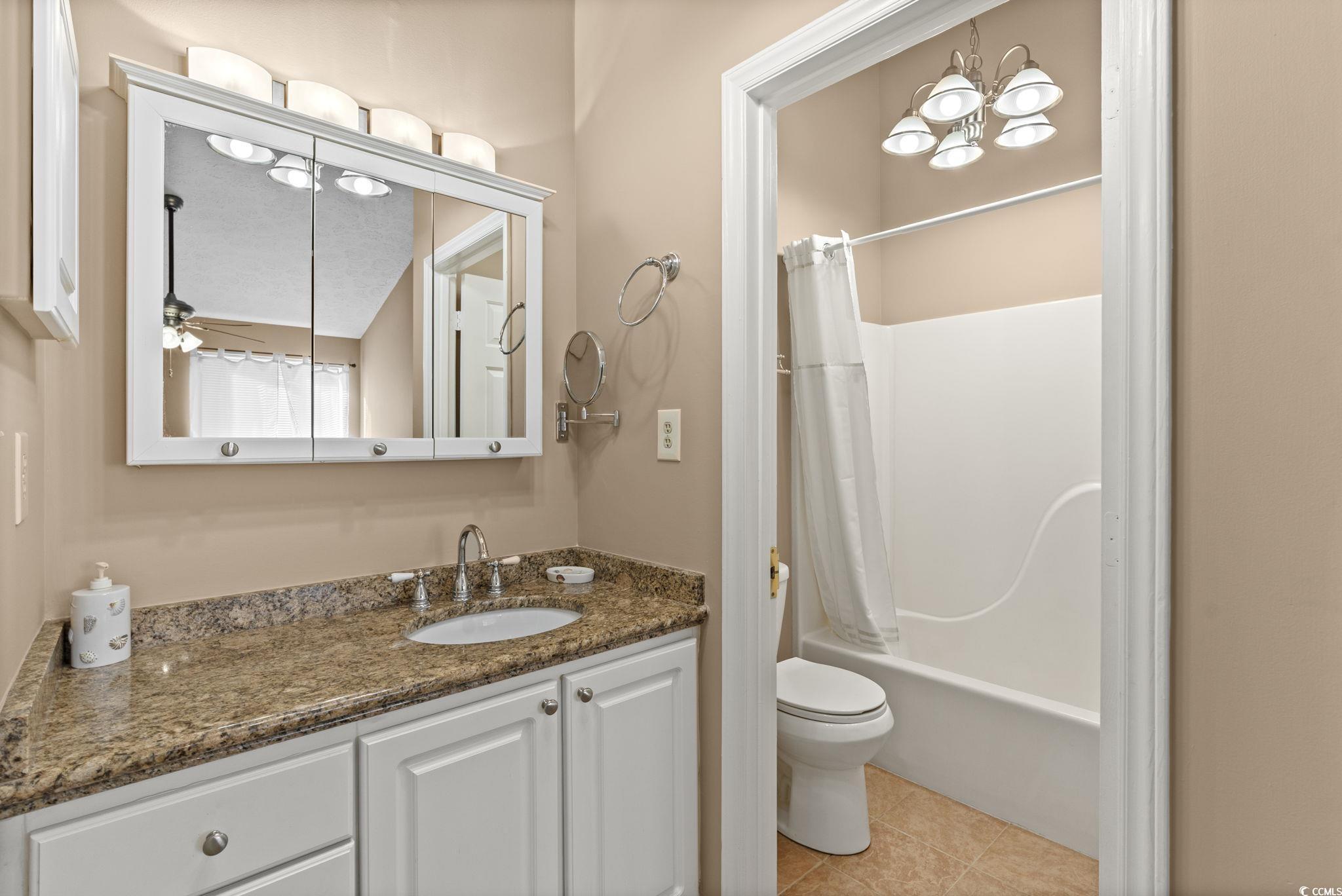 613 14th Avenue South, Unit 34 Surfside Beach, SC 29575 - Photo 15 of 37 Bathroom featuring vanity, shower / tub combo, light tile patterned floors, and a chandelier