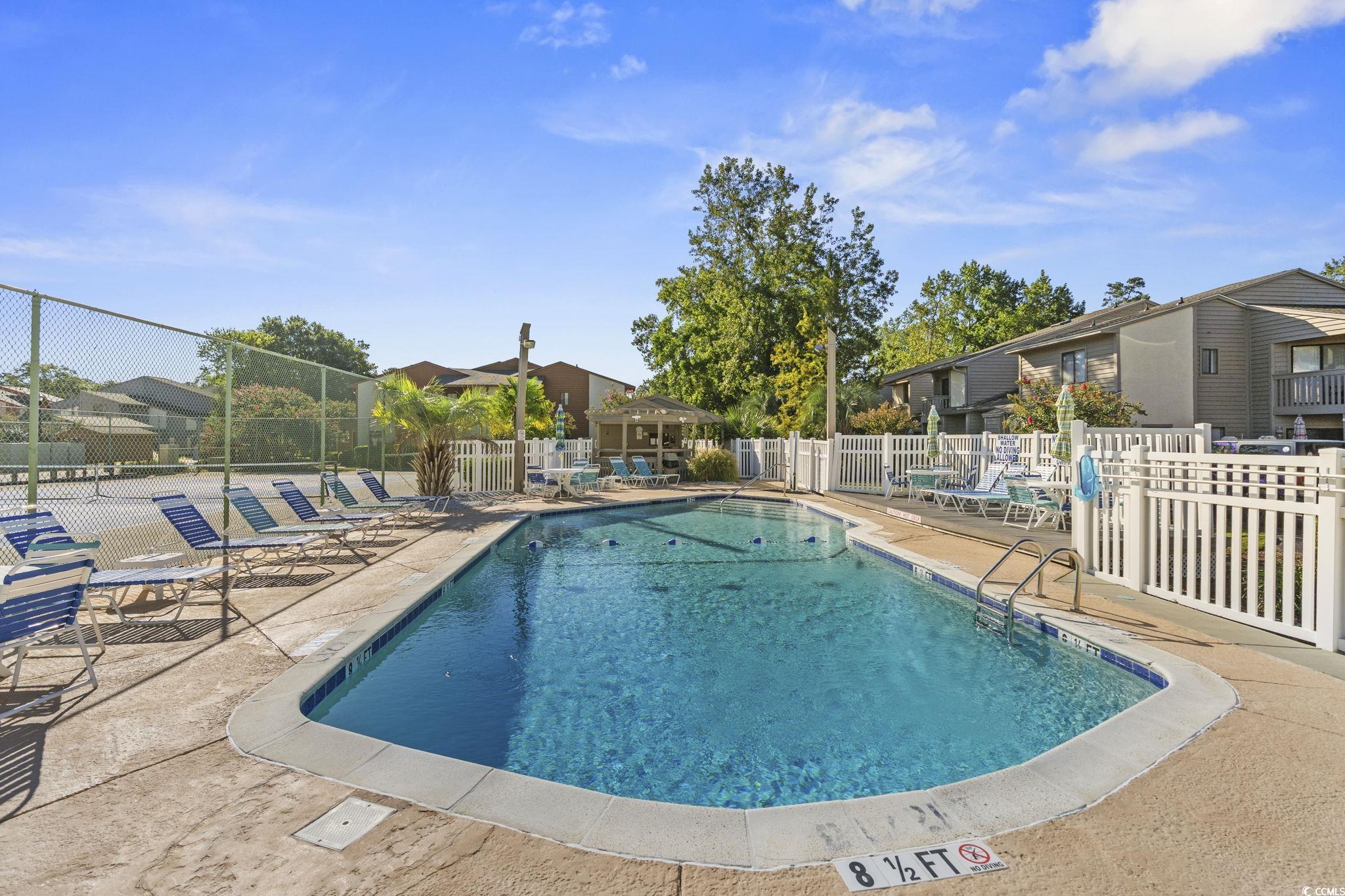 613 14th Avenue South, Unit 34 Surfside Beach, SC 29575 - Photo 27 of 37 Community pool featuring a patio and a residential view