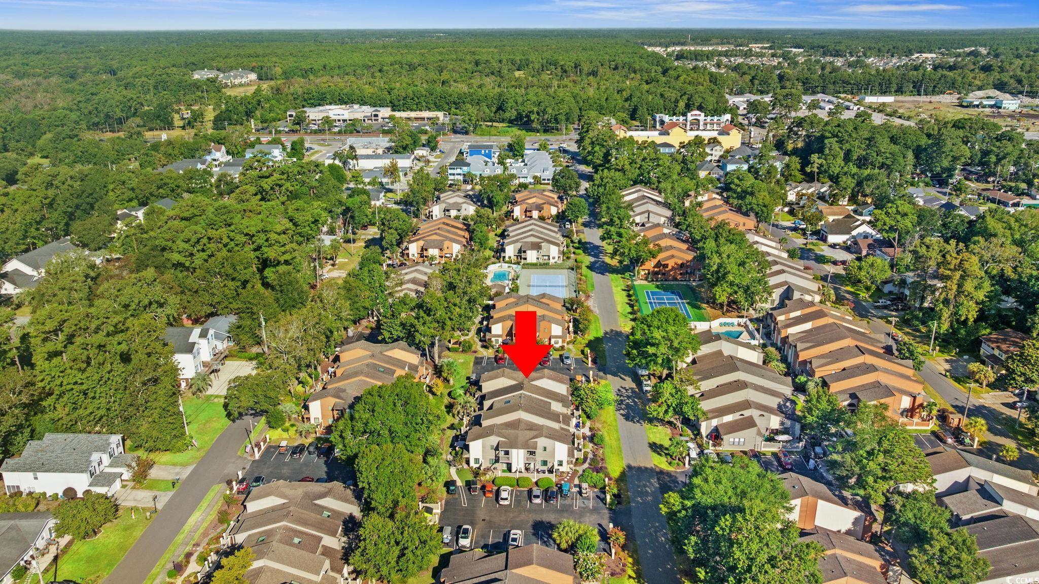 613 14th Avenue South, Unit 34 Surfside Beach, SC 29575 - Photo 34 of 37 Aerial view of property and surrounding area featuring nearby suburban area and a heavily wooded area