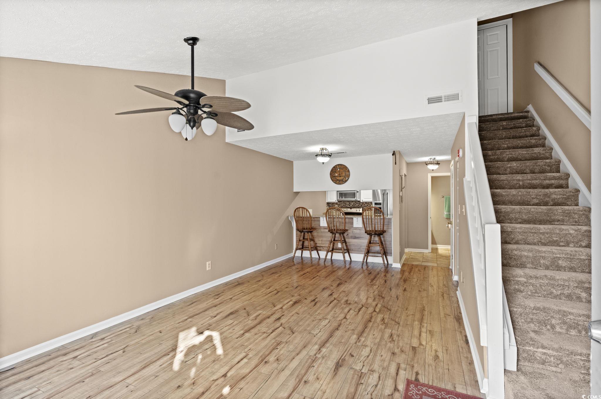 613 14th Avenue South, Unit 34 Surfside Beach, SC 29575 - Photo 4 of 37 Sitting room featuring a textured ceiling, light wood-style floors, stairs, and ceiling fan