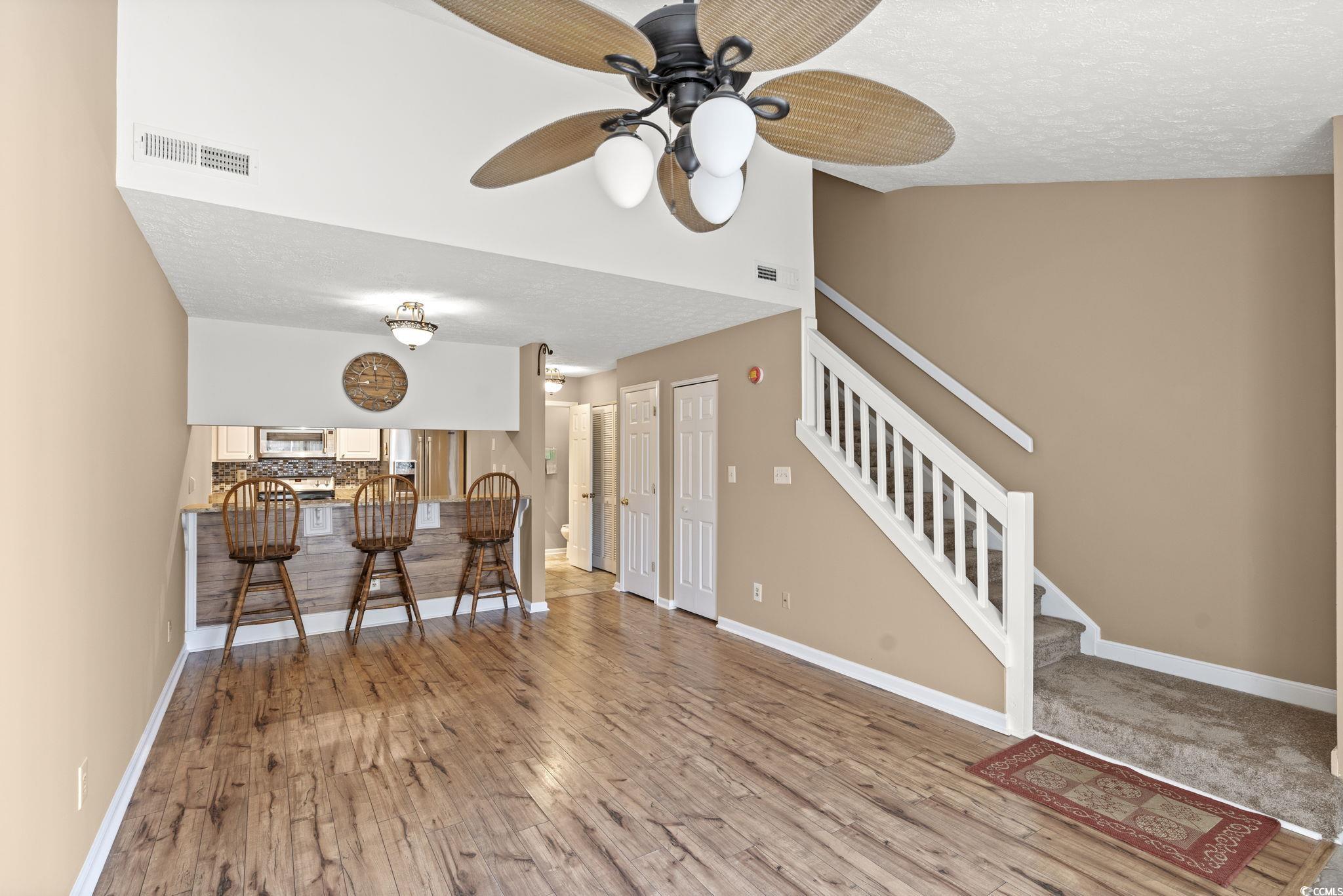 613 14th Avenue South, Unit 34 Surfside Beach, SC 29575 - Photo 5 of 37 Living area featuring a textured ceiling, stairway, light wood-type flooring, and a ceiling fan