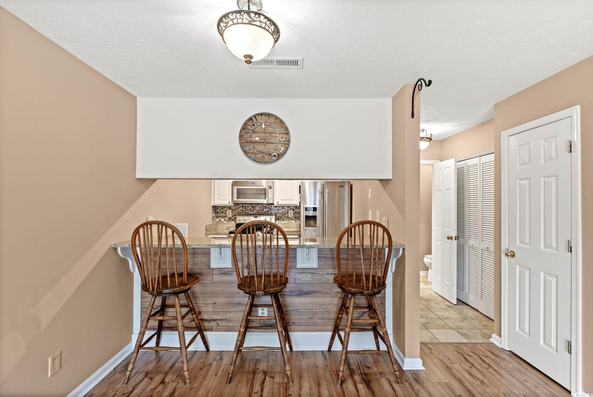 613 14th Avenue South, Unit 34 Surfside Beach, SC 29575 - Photo 6 of 37 Dining space featuring light wood finished floors and a textured ceiling