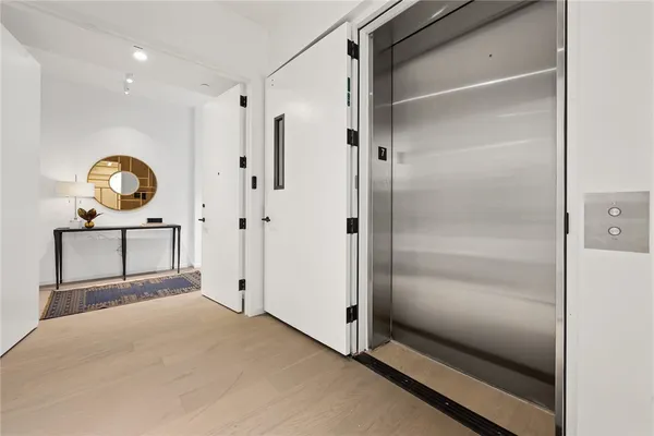 a view of a hallway with wooden floor