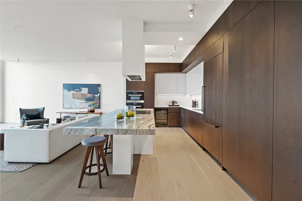 a kitchen with a sink a counter top space stainless steel appliances