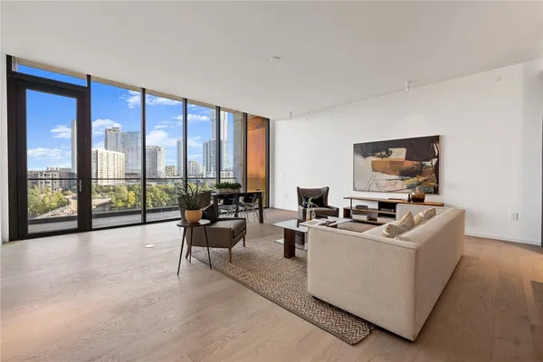 a living room with furniture and large windows