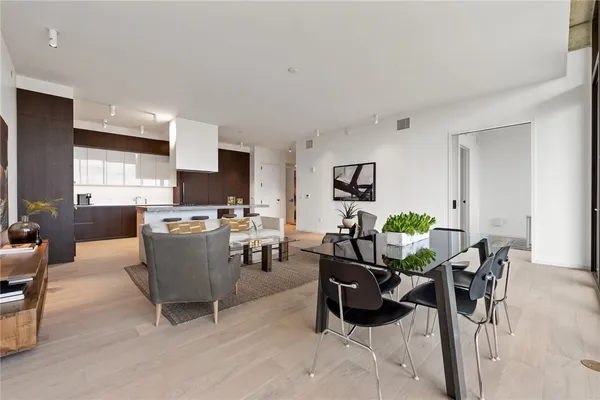 a living room with furniture and kitchen view