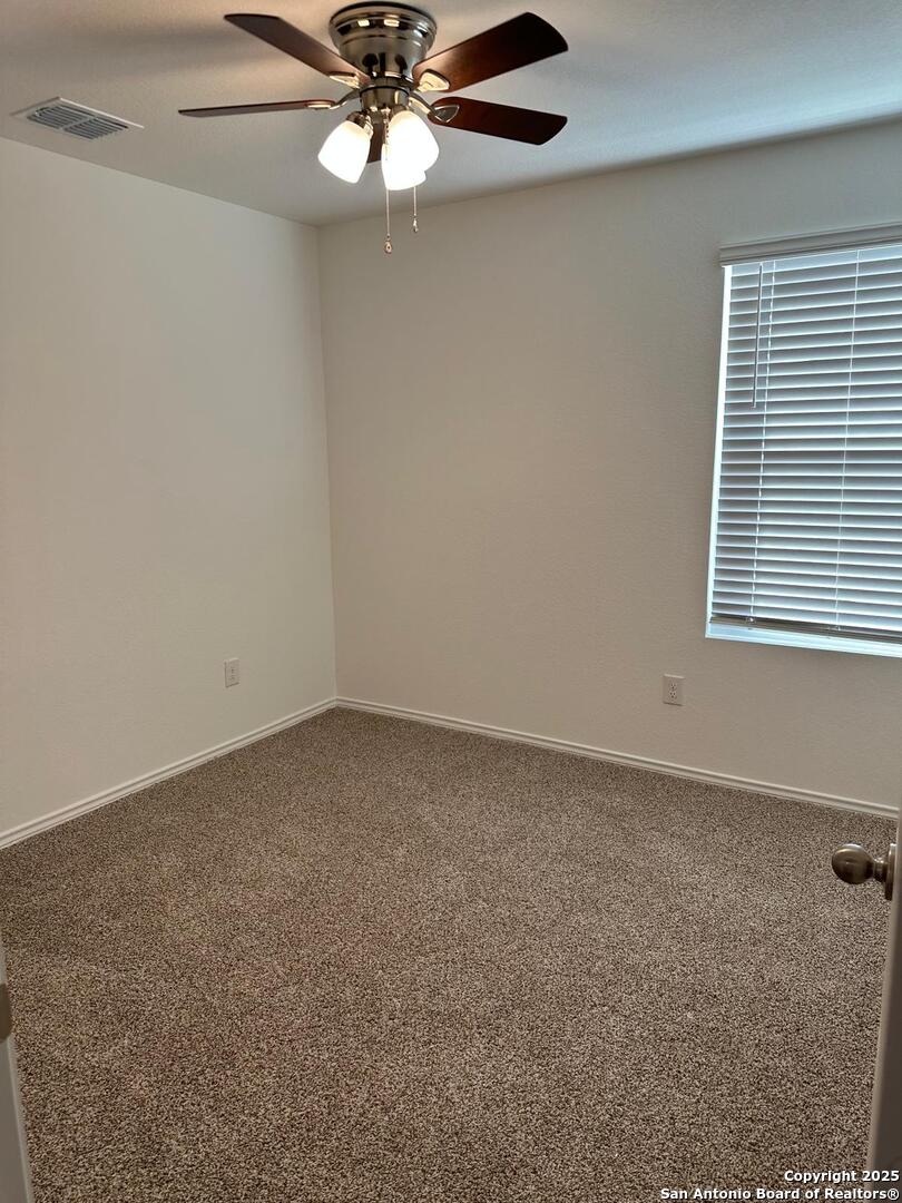 5032 Pitch Mark San Antonio, TX 78261 - Photo 13 of 21 an empty room with a window and a fan