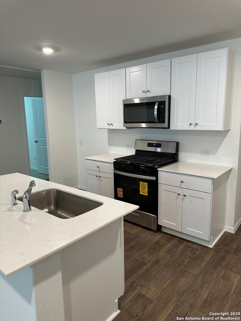 5032 Pitch Mark San Antonio, TX 78261 - Photo 5 of 21 a kitchen with granite countertop a sink stove and refrigerator
