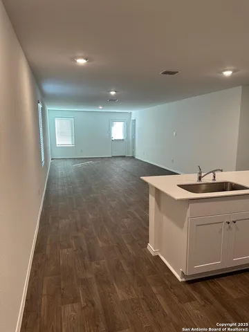 a view of a kitchen with a sink and dishwasher cabinets