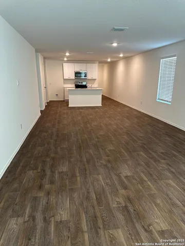 a view of kitchen with microwave and cabinets