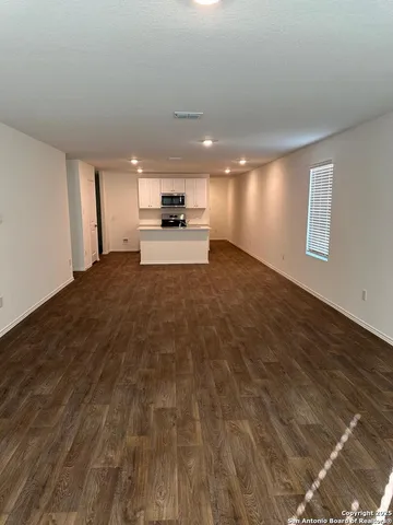 an empty room with wooden floor