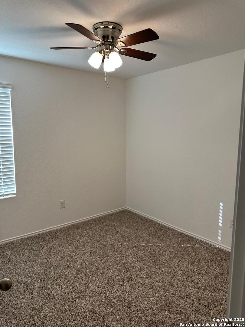 5032 Pitch Mark San Antonio, TX 78261 - Photo 10 of 21 a view of an empty room with a chandelier fan