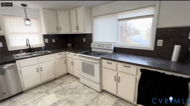 a kitchen with white cabinets and white appliances