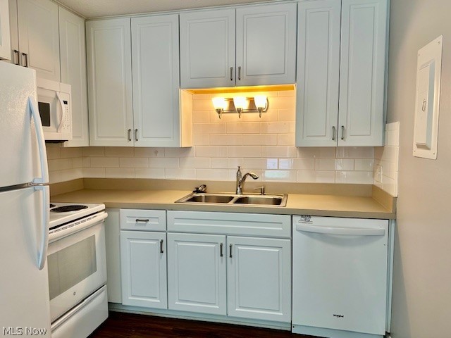 4376 Darrow Road, Unit 2 Stow, OH 44224 - Photo 10 of 26 Kitchen with white appliances, a sink, light countertops, backsplash, and white cabinets