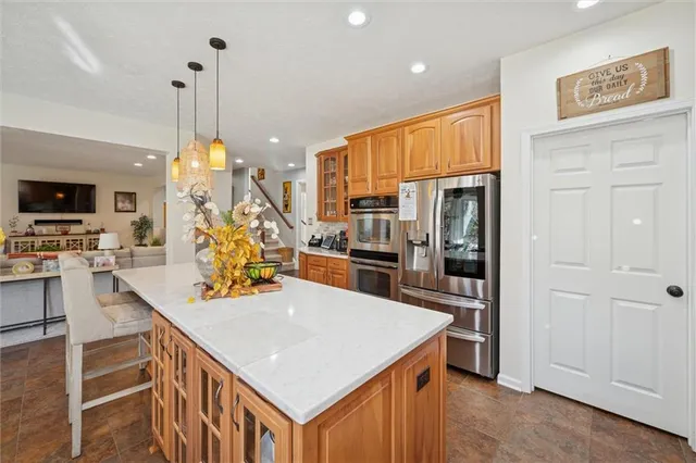 a dining room with furniture large windows and wooden floor