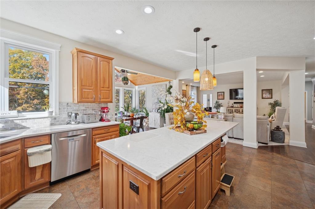 1005 Autumn Woods Drive Coraopolis, PA 15108 - Photo 14 of 50 a kitchen with a stove a sink a refrigerator and a dining table with wooden floor