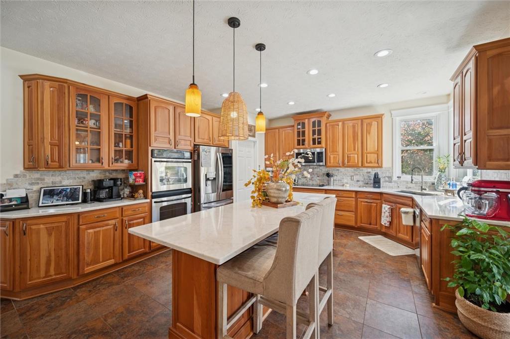 1005 Autumn Woods Drive Coraopolis, PA 15108 - Photo 15 of 50 a kitchen with stainless steel appliances granite countertop a kitchen island hardwood floor sink stove and granite counter top