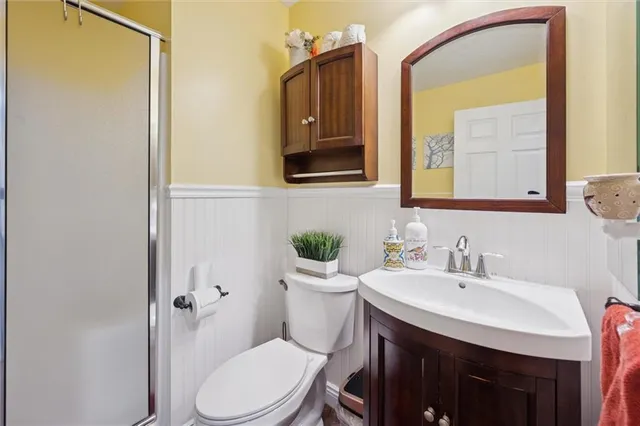a bathroom with a granite countertop vanity mirror and a bathtub