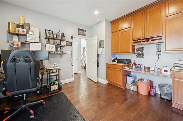a bathroom with a granite countertop sink toilet a mirror and shower