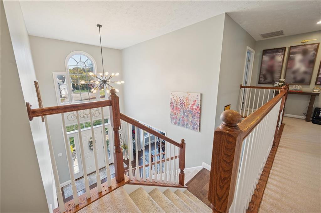 1005 Autumn Woods Drive Coraopolis, PA 15108 - Photo 24 of 50 a view of an entryway wooden floor and chandelier