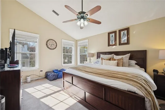 a bed room with a bed a couch and a window